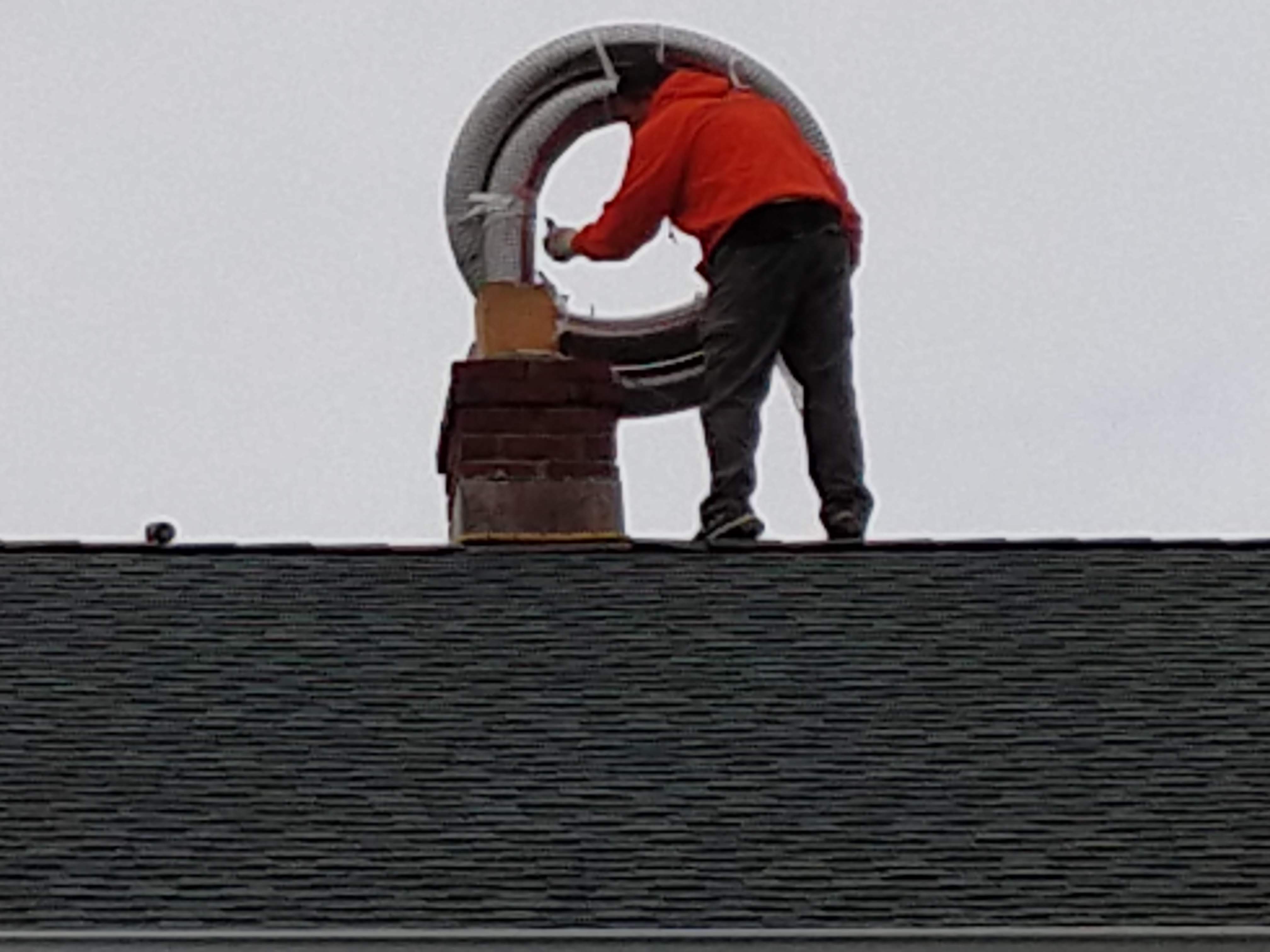 Flexible stainless chimney liner being installed in West Hampton, New York